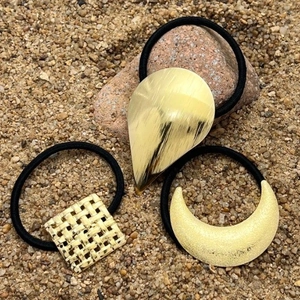 Set of 3 gold metal ponytail holders with drop, moon, and square charms on black bands