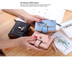 Close-up of PU leather wallets featuring hollow leaf patterns and gold metal leaf charms