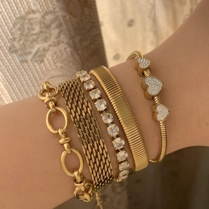 Golden five-piece layered bracelet set with sparkling crystals and wide mesh watch band style