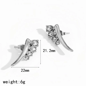 Detail view of silver curved leaf earrings with marquise-cut zircons and size dimensions