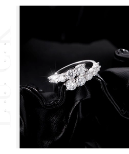 Macro shot of s925 silver ring featuring layered crossover band and sparkling diamonds