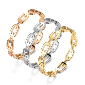Polished chain link rings in gold, silver, and rose gold finish on white background