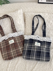 Vintage plaid tote bag with white lace trim and Happy patch on soft fabric background