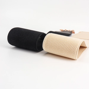 Detail view of woven elastic belts in black and beige with chain and waffle texture