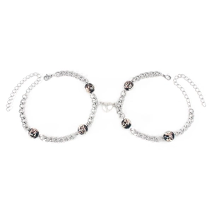 Close-up of magnetic heart clasp connecting two luminous bead Cuban chain bracelets