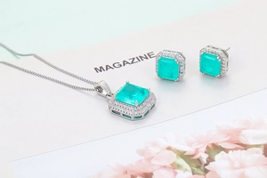 Elegant silver jewelry set with square emerald stones and white crystal halo