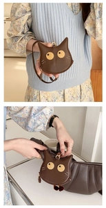 Detailed close-up of a brown cute cat PU leather neck mini wallet and bag charm