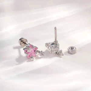 Pink and blue star-shaped titanium steel stud earrings with wing and screw-back detail