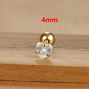 Close-up of 4mm heart-shaped zircon earring with gold screw back on wood stand