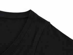 Detailed view of the V-neck stitching and fine knit texture on this black wool blend top