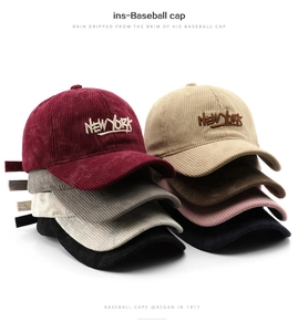 Detailed stack of corduroy baseball caps in various colors with New York embroidery