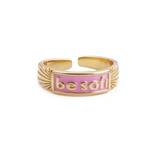 Detail of gold-plated open ring with pink enamel inlay and BE SOFT lettering
