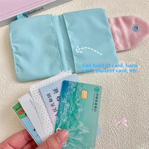 Detail of light blue fabric card holder with pink plush flap and dual card slots