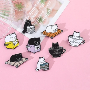Set of 8 cute cat metal pins showing cats reading and drinking coffee on pink background