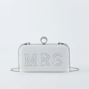 Detail of white beaded MRS clutch bag with silver chain strap and ring-shaped rhinestone clasp