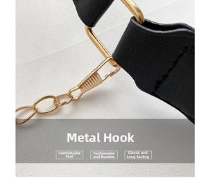 Detail of adjustable black leather strap with gold lobster clasp and metal hardware hooks
