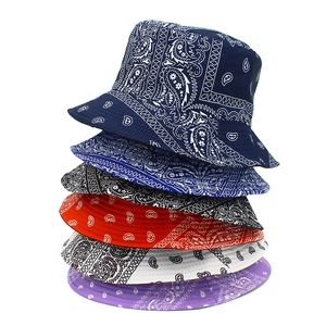 Vertical stack of six colorful paisley double-sided cotton bucket hats in neutral background