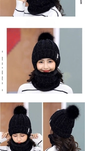 Detail of black knitted beanie set with silver sequins and faux fur pom-pom with B patch