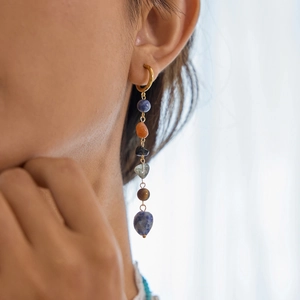 Close-up of dangling 18K gold stainless steel earrings with colorful natural stones