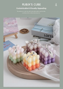Close-up of cube bubble candles in gradient colors on wooden tray with art decor