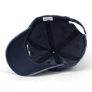 Detailed interior of washed cotton baseball cap with adjustable strap and 100% cotton label