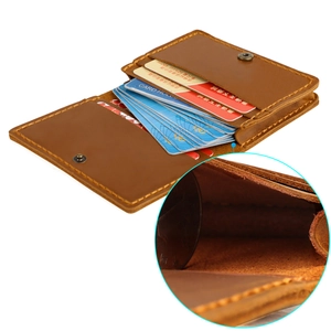 Detail view of brown crazy horse leather card holder with coin pocket and neat stitching