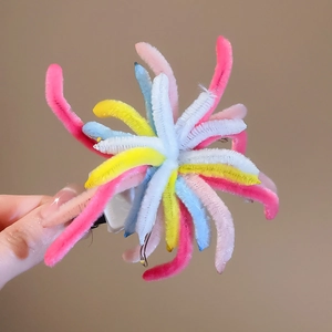Detail of colorful plush twist stick firework hair clip with soft pastel textures