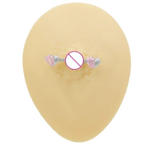 Detail of pink heart zircon nipple ring on a silicone model with silver metal barbell