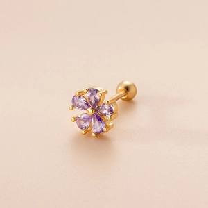 Detailed view of golden flower cartilage stud with purple zircon petal setting