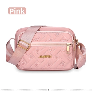 Detail of pink quilted oxford bag with heart embroidery and golden metal zipper