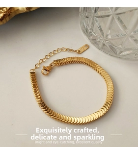 Detail of 18KGP gold fish scale bracelet featuring adjustable lobster clasp and tag