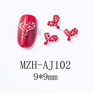 Macro detail of 9x9mm red heart nail art rhinestones with metallic silver base
