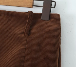 Close-up of caramel corduroy skirt showing waistband details and fabric texture