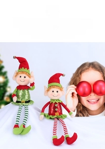 Close-up of red and green sequined Christmas elf plush dolls with striped legs