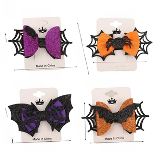 Set of Halloween bow hair clips featuring spider and bat motifs with size measurements
