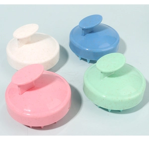 Detail view of four colorful silicone scalp massage brushes with ergonomic handles