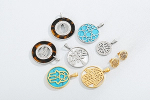 Flat lay of gold and silver tree of life pendants with turquoise stone accents
