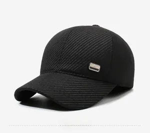 Detail showing the metal fashion plaque and twill fabric texture of the black baseball cap