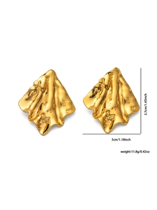 Macro shot of gold irregular molten texture earrings with pleated flame pattern details