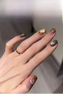 Detail view of leopard cat eye press-on nails with gold foil and glossy gradient finish