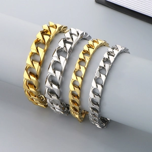 Chunky hip-hop style Cuban link bracelets in gold and silver finish on display stand