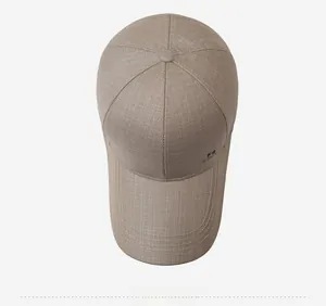 Top view of khaki baseball cap with long brim and FS logo print on light background