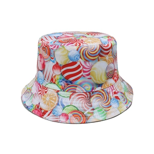 Close-up of vibrant bucket hat with colorful lollipop and orange slice print patterns