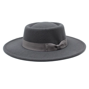 Detail of dark grey wool felt fedora hat featuring a matching grosgrain ribbon bow