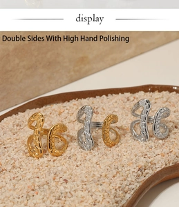 Detail showing wave texture and high hand polishing on gold and silver open rings