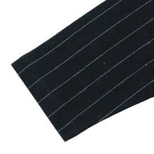 Detailed close-up of dark striped shirt sleeve cuff and high-quality fabric texture