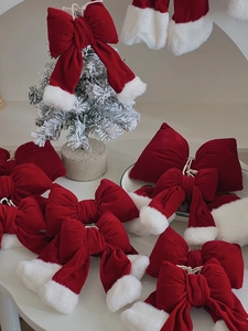 Detail of red velvet Christmas bows with white faux fur trim for DIY holiday decor