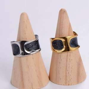 Irregular hollow H-shaped open ring in gold and silver finish on wooden stand