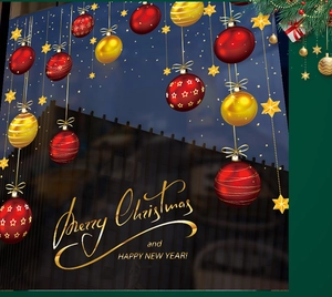 Detailed view of red and gold Christmas ball ornaments and stars with festive typography