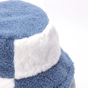 Winter plush bucket hat in blue and white faux fur with warm fleece patchwork texture